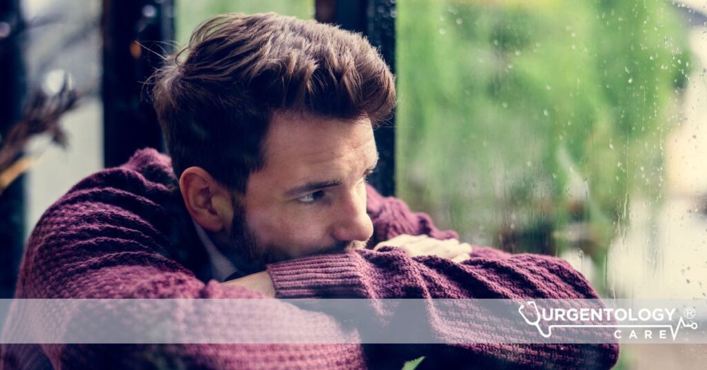 sad man looking out window
