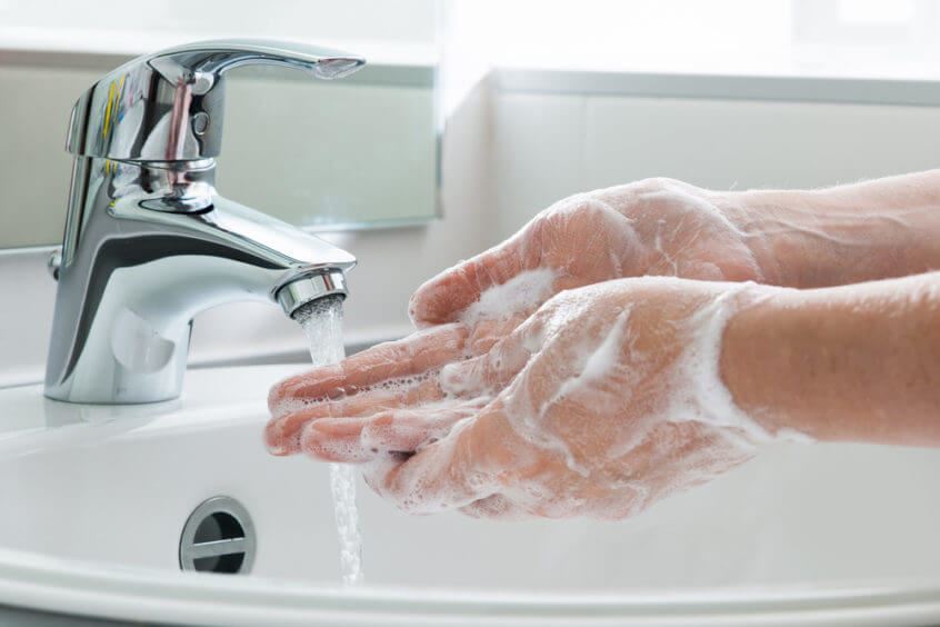close up of someone washing their hands